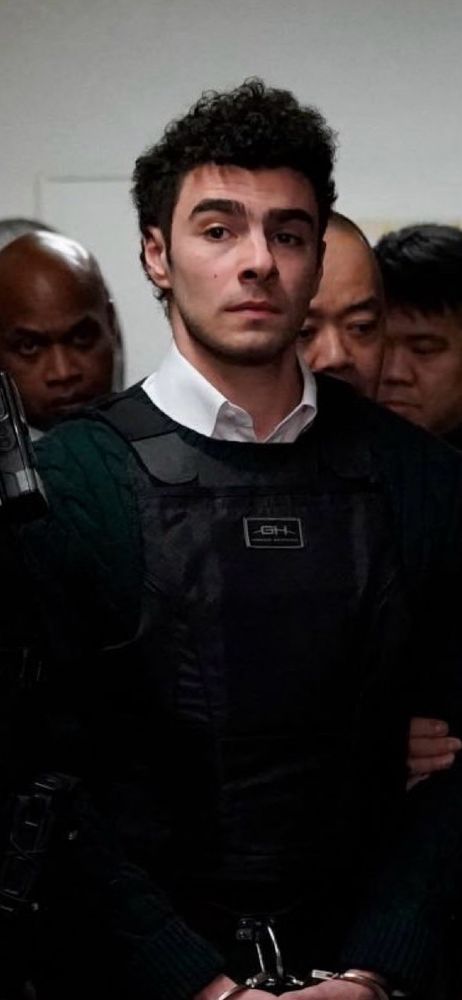 Luigi Mangioni looking especially handsome, being led into court by entirely too many deputies. 