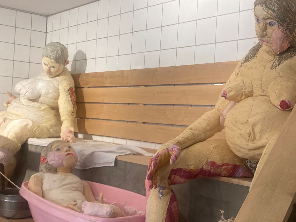 Three cloth sculptures: two women and a child