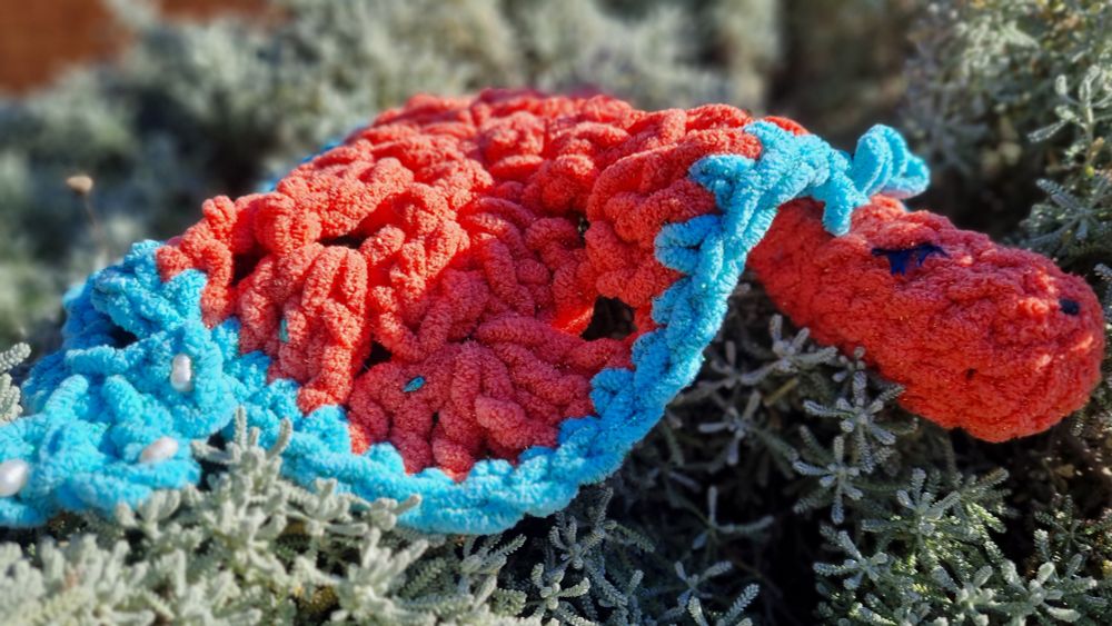 Sleepy dragon is curled up in a bush, enjoying the morning sun