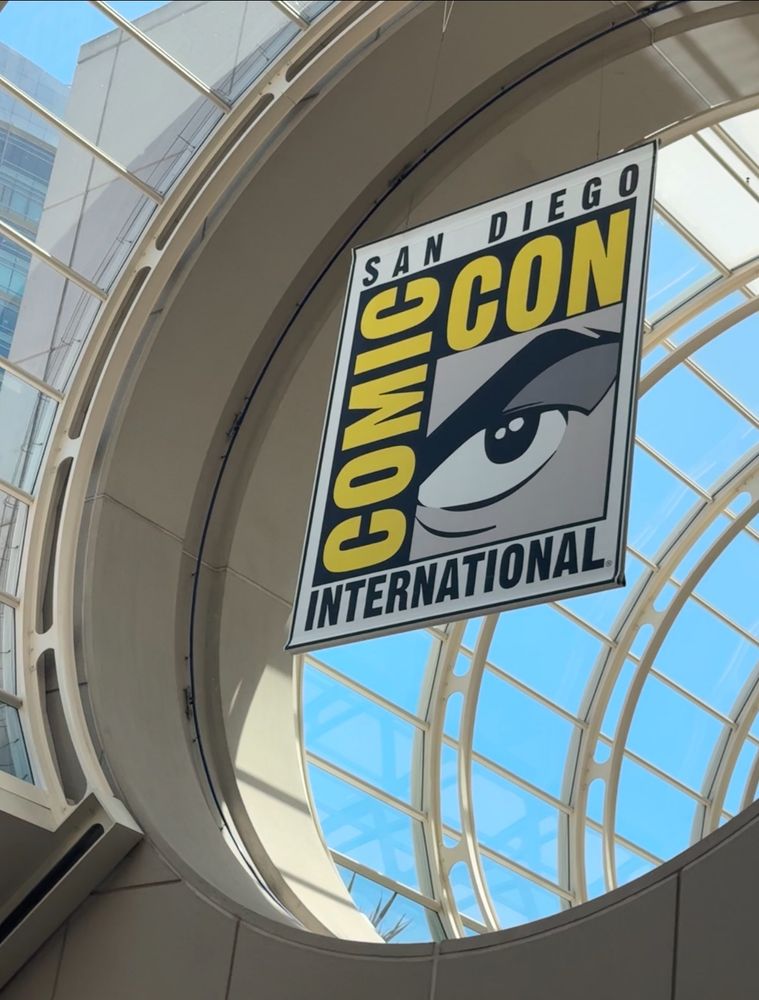 A photo of a comic Con international banner inside the vaulted ceilings of the San Diego convention center