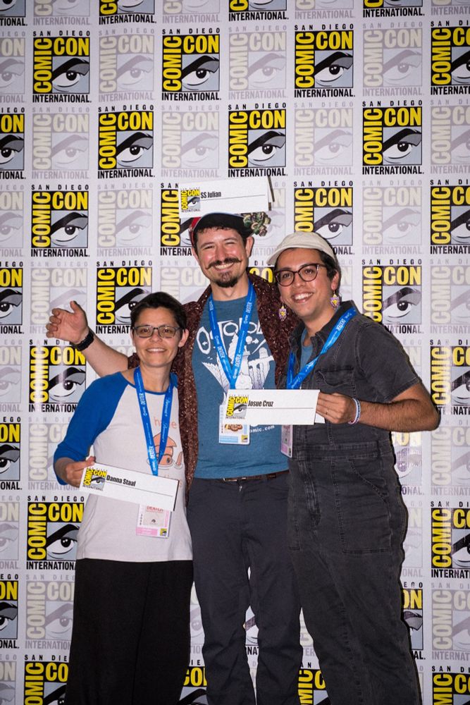 A photo of Danna Staaf, SS Julian, and Josue Cruz at San Diego comic-con