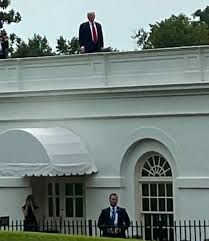 Trump stood on a flat roof.  Oh how I wish he was about to jump....