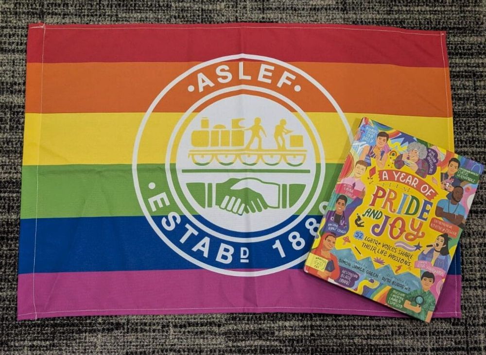 'A Year of Pride and Joy' book by a LGBT+ ASLEF flag