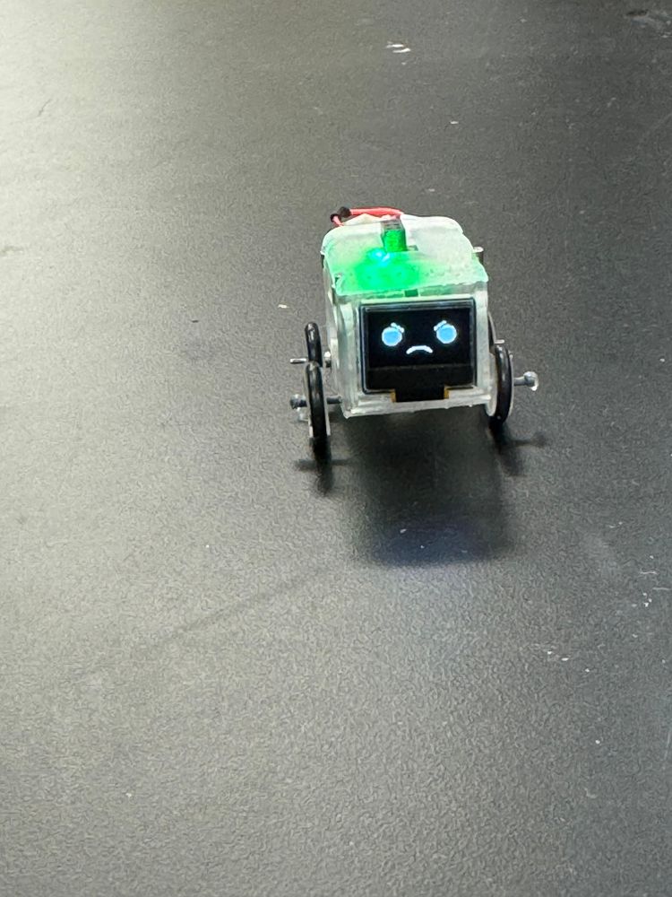Mini robot displaying a sad face.
