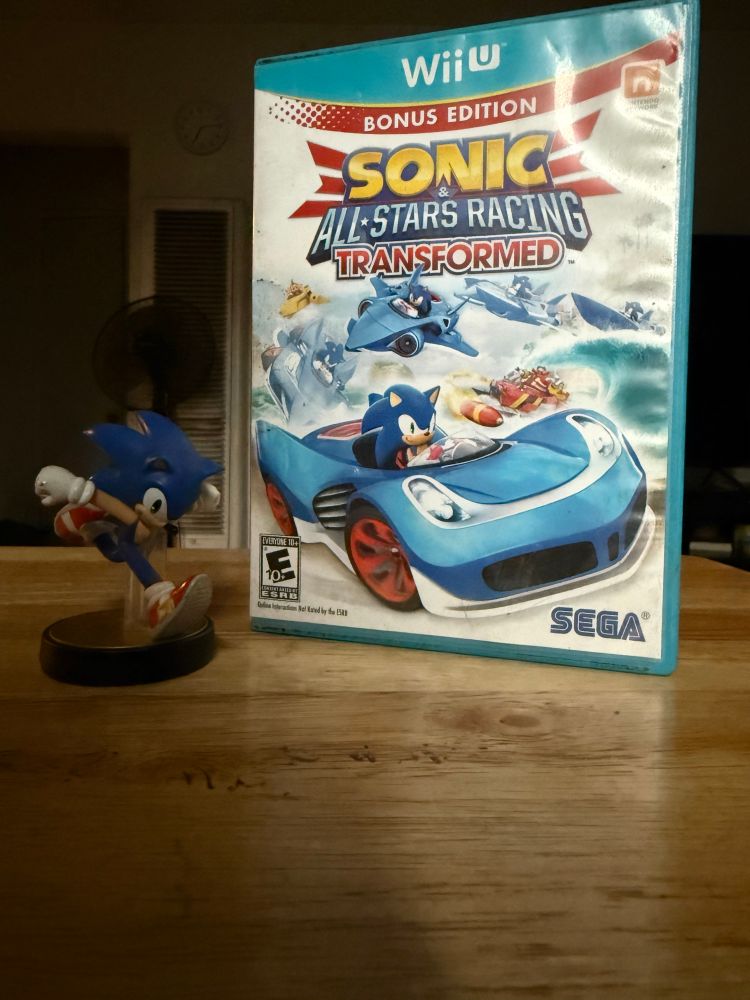 Sonic the Hedgehog amiibo next to a physical copy of Sonic & All-Stars Racing Transformed