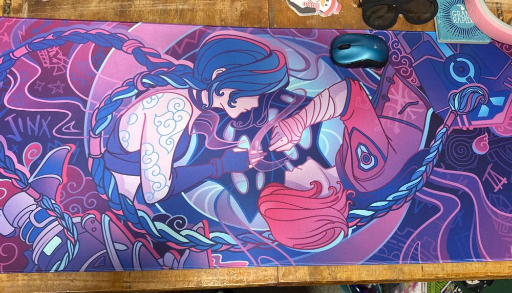 Arcane characters Jinx and Vi laying on their sides facing each other, in a yin-yang pose