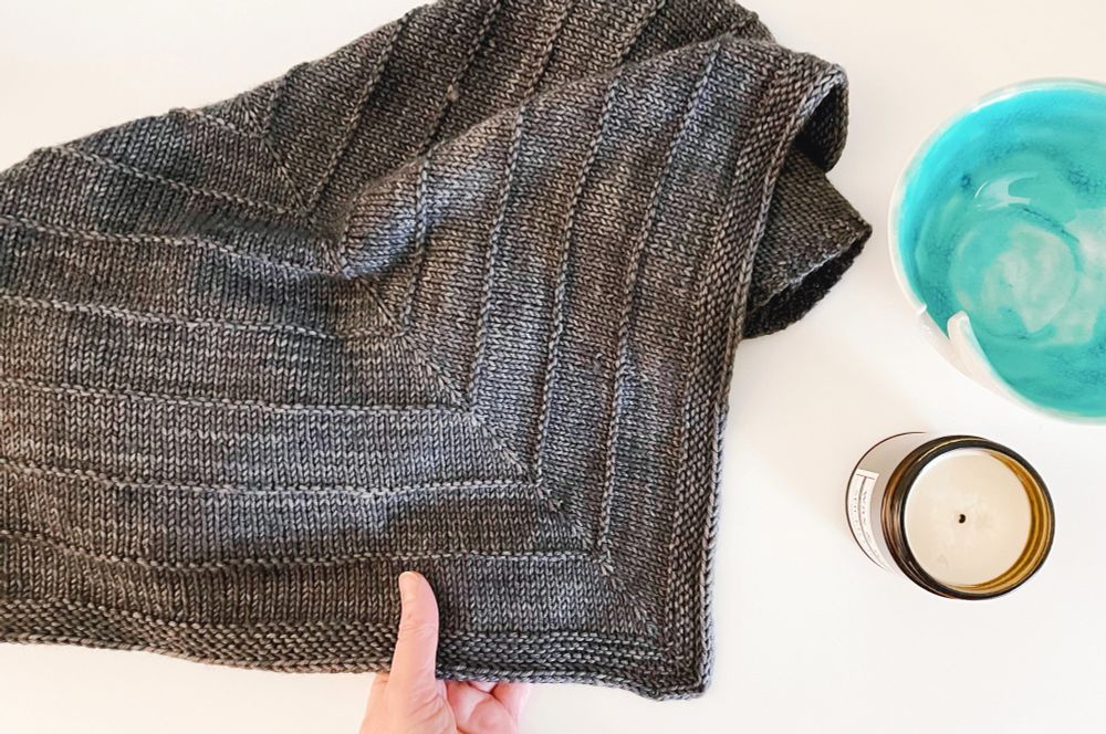 A handknit oversized triangle shawl.