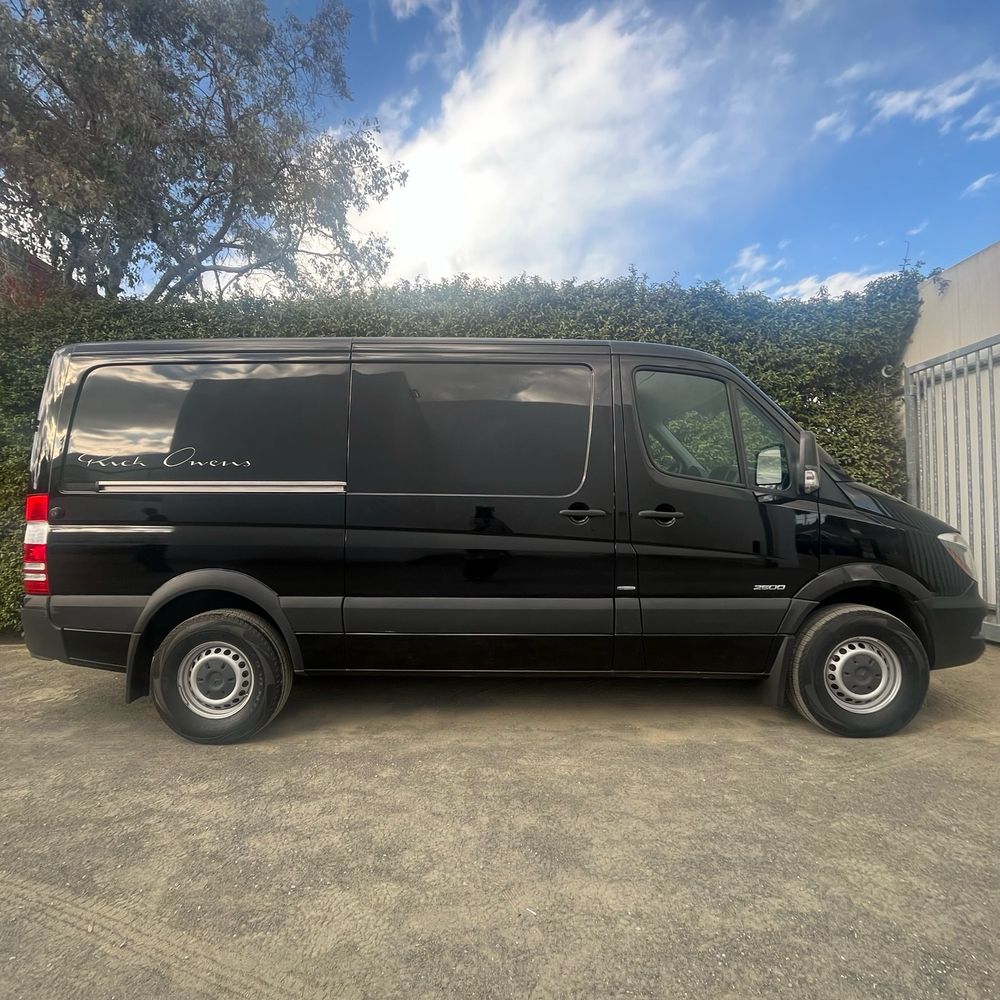 A black Mercedes van, with “Rick Owens” on the side in his signature.