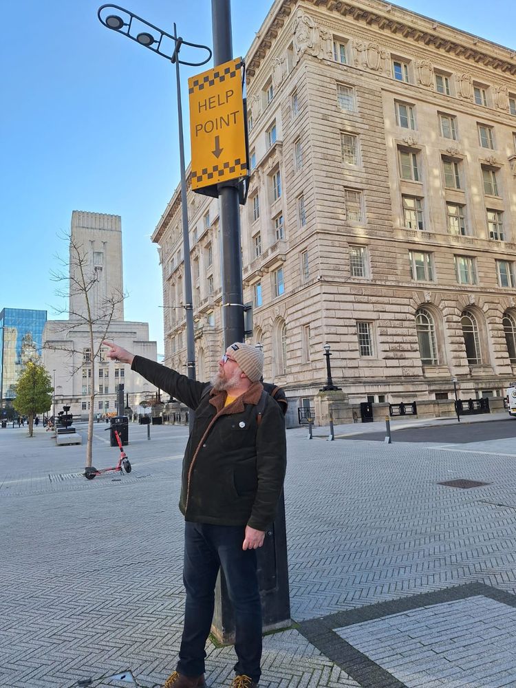 Me pointing and there is a sign above me saying "HELP POINT ⬇️"