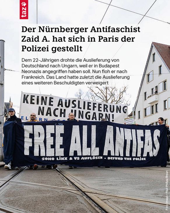 Teilnehmer*innen einer Demonstration halten Banner hoch: „Keine Auslieferung nach Ungarn“ und „Free all Antifas“. Text: Der Nürnberger Antifaschist Zaid A. hat sich in Paris der Polizei gestellt. Dem 22-Jährigen drohte die Auslieferung von Deutschland nach Ungarn, weil er in Budapest Neonazis angegriffen haben soll. Nun floh er nach Frankreich. Das Land hatte zuletzt die Auslieferung eines weiteren Beschuldigten verweigert