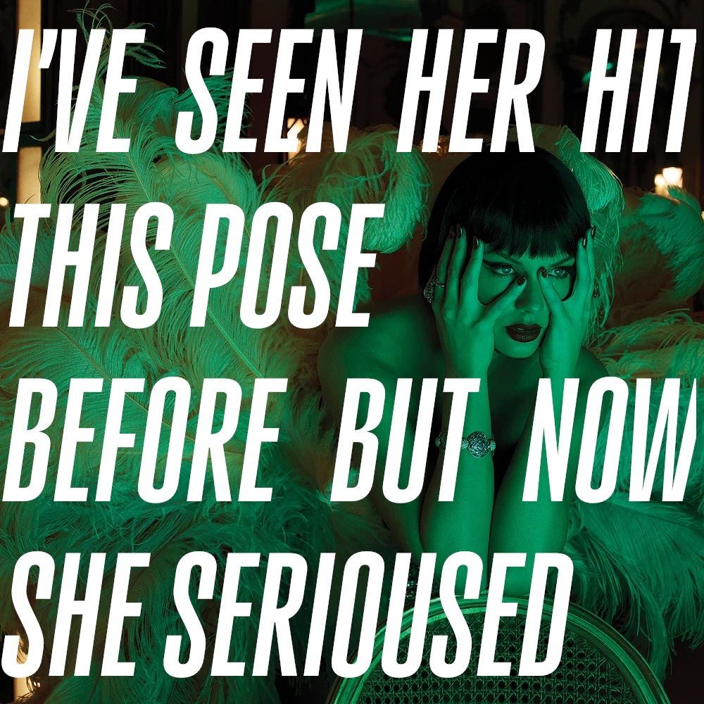 A green photo from The Life of a Showgirl photoshoot where Taylor is covering her face with both her pinkies, very similar to the Reputation photoshoot photo.
The text over the photo says "I'VE SEEN HER HIT THIS POSE BEFORE BUT NOW SHE SERIOUSED"
