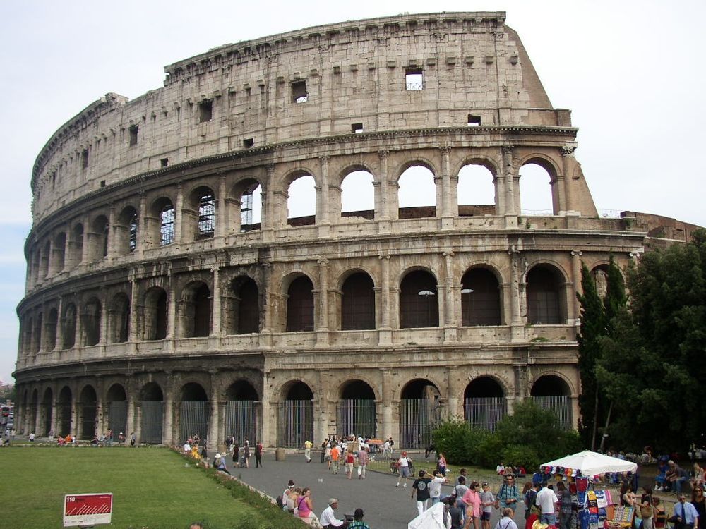 A photo of Colosseum in Rome, Italy. It's obviously unfinished, lacking paint, and there is some construction scaffolding all around