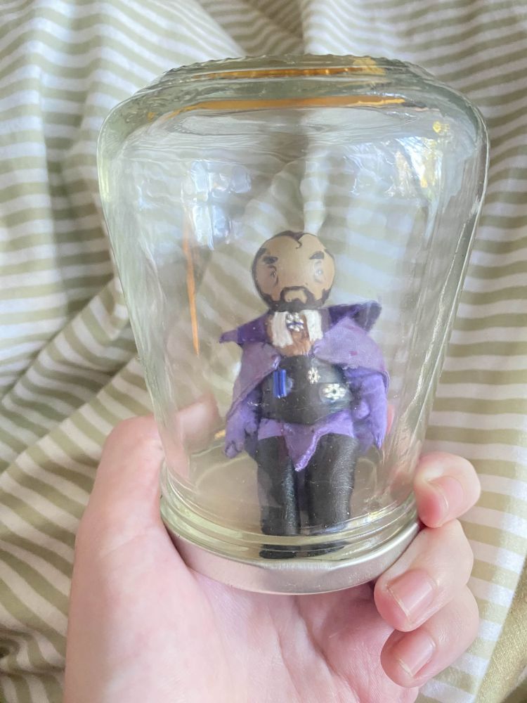 a picture of the little lucanis doll inside a jam jar. free him. 