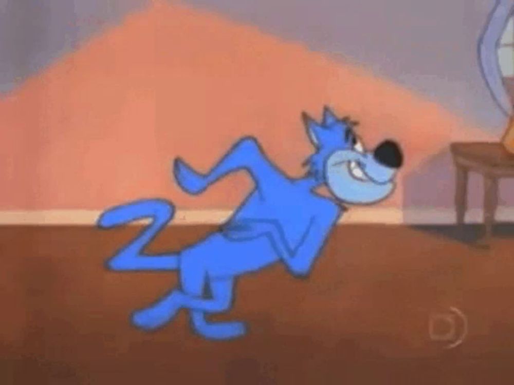 a blue cartoon cat is standing on its hind legs in front of a chair .