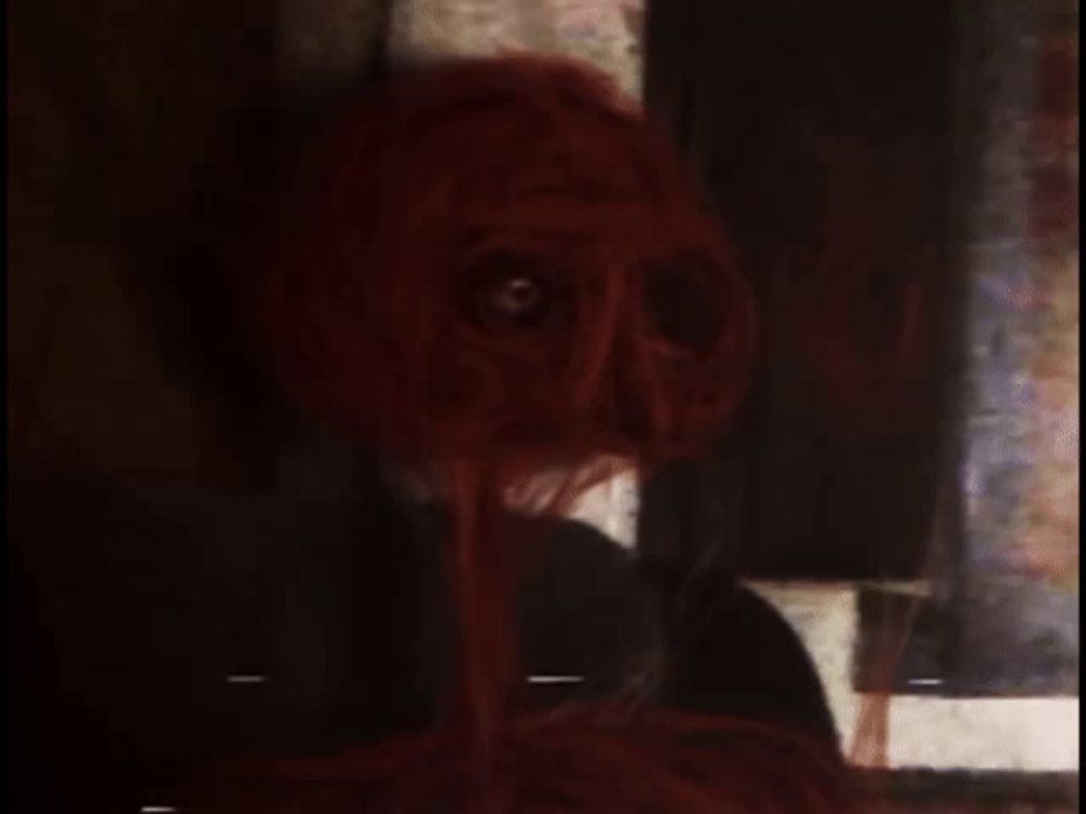 a close up of a person 's face with spaghetti coming out of it 's eyes