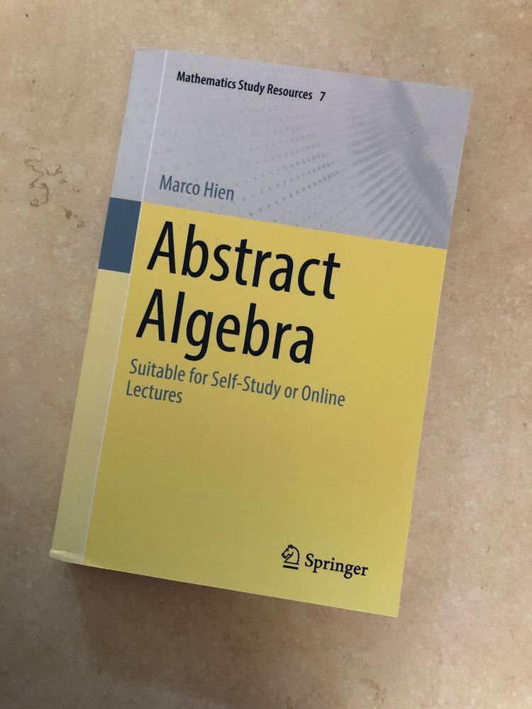 A photograph of the cover of Abstract Algebra by Marco Hein.