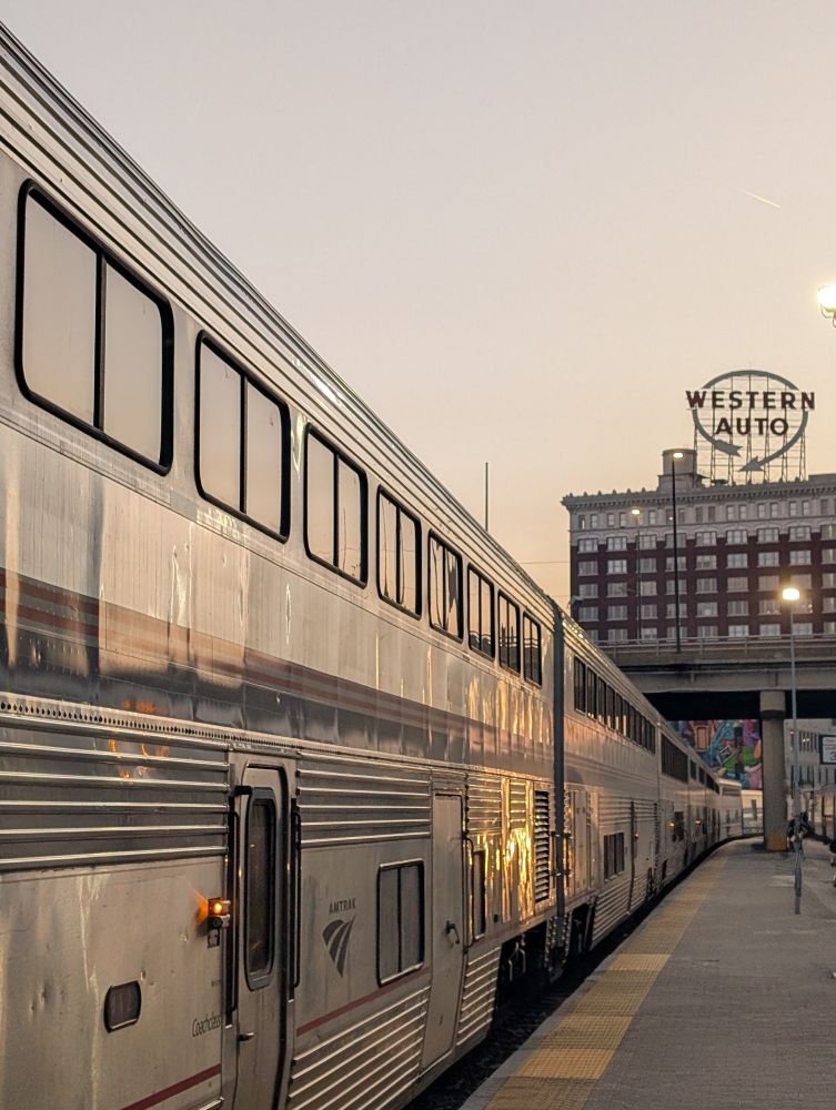 Train platform at Kansas City Union Station, with the Southwest Chief waiting to load. In the background the Western Auto sign looms. 