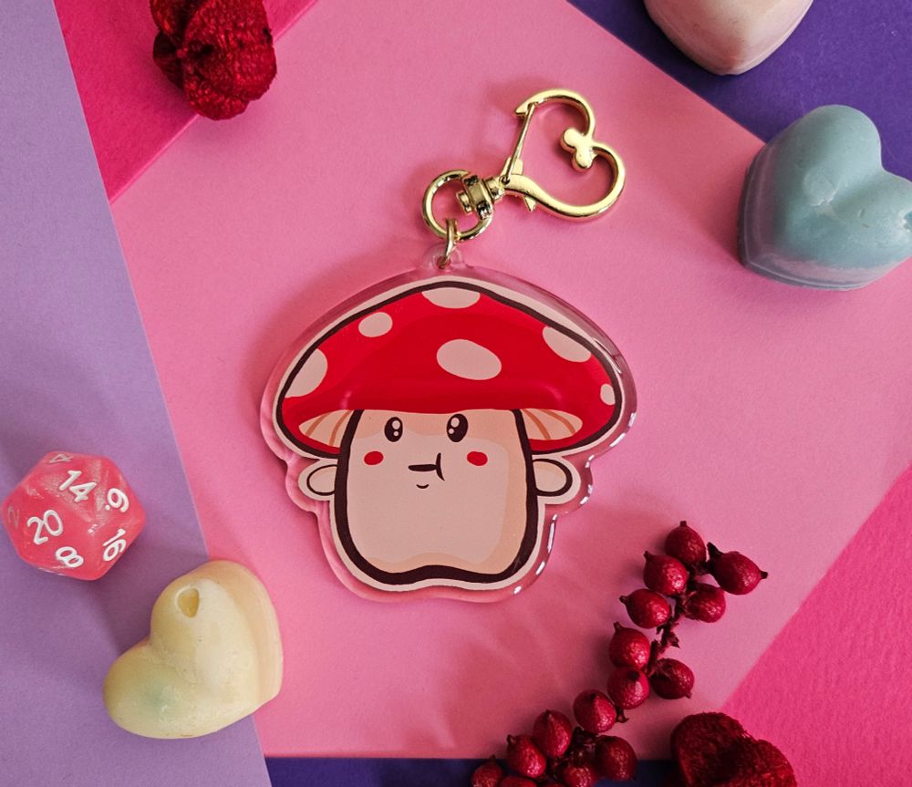 An acrylic keychain of a cute redcap mushroom person