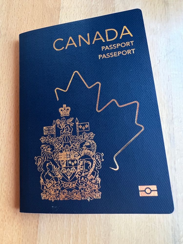 Canadian passport: blue background with stylized maple leaf silhouette embossed in gold. Welcome for visa free travel in 118 countries!
And - just saying - to flee north from US should need be.