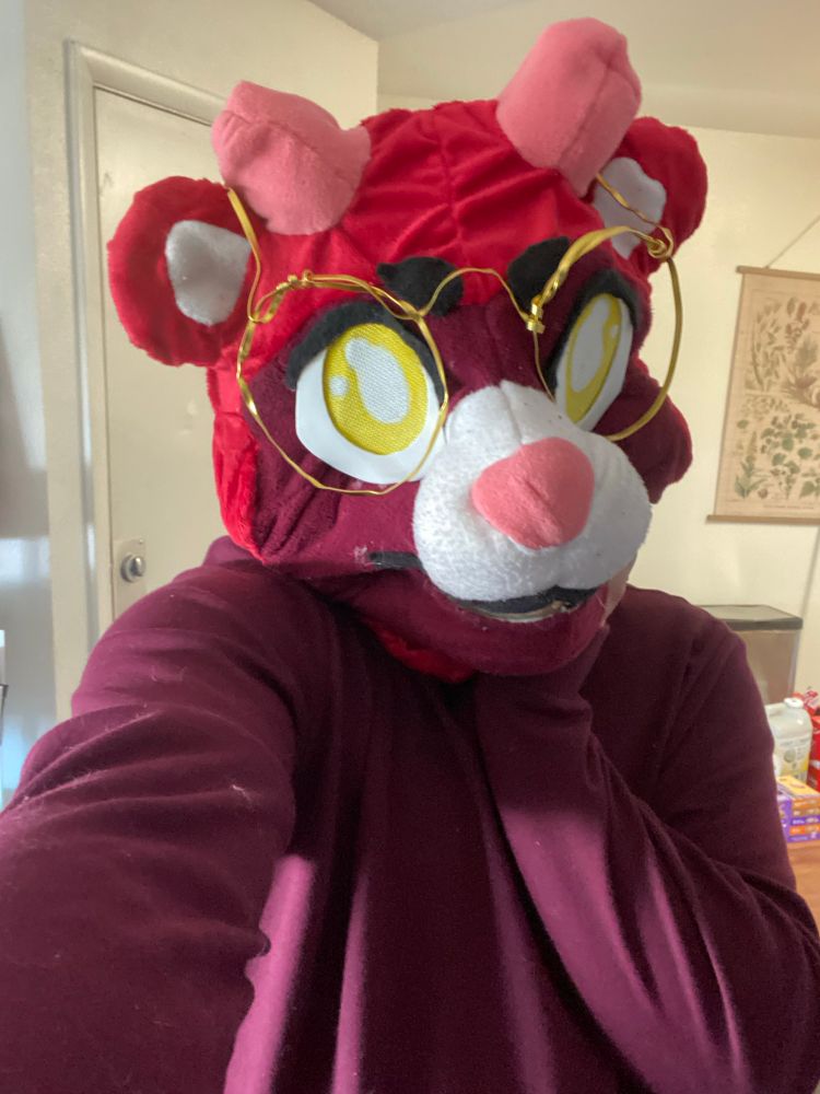 A selfie of a red bear fursuit head