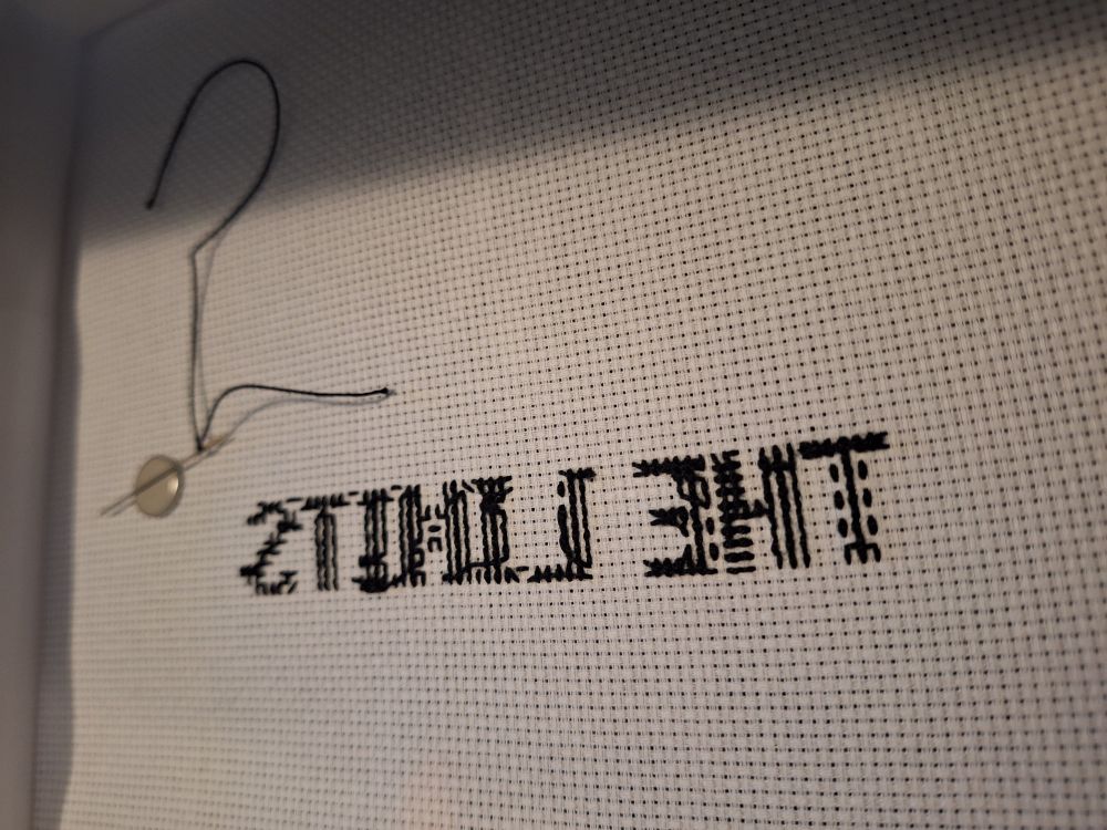 A picture of my threads on the back of the project. I'm practicing better stitches!