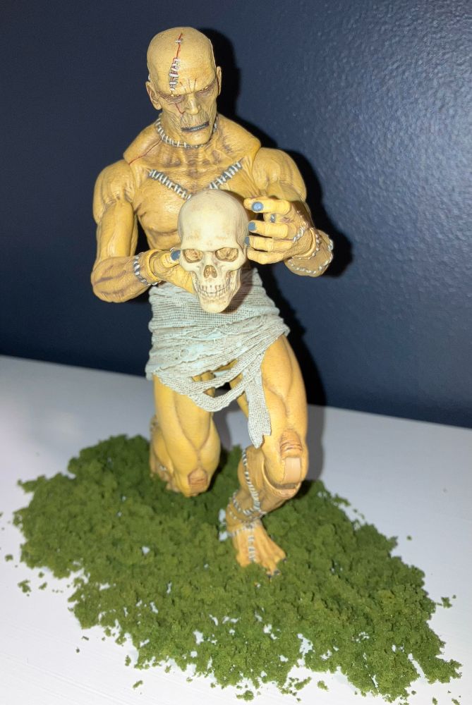 Four Horsemen Frankenstein's Creature figure posed with a skull