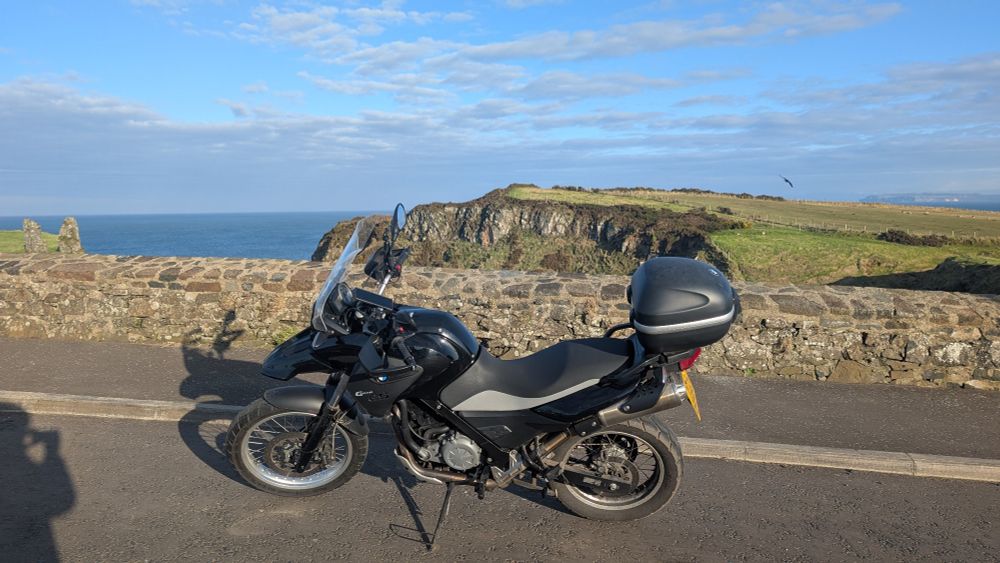 Black Motorbike in front of the sea and coast
