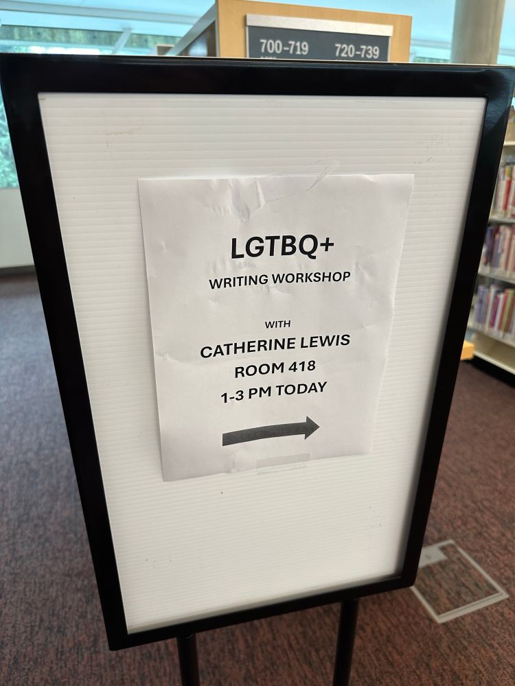 Signage stating “LGTBQ+ Writing Workshop with Catherine Lewis”
