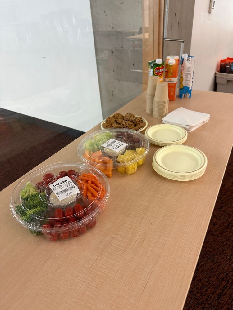 Trays of veggies, fruit, and cookies on a table