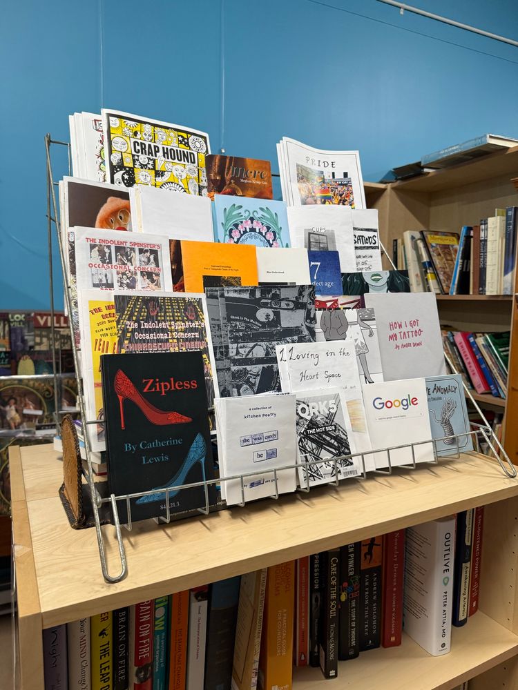Display rack containing zines and chapbooks including ZIPLESS
