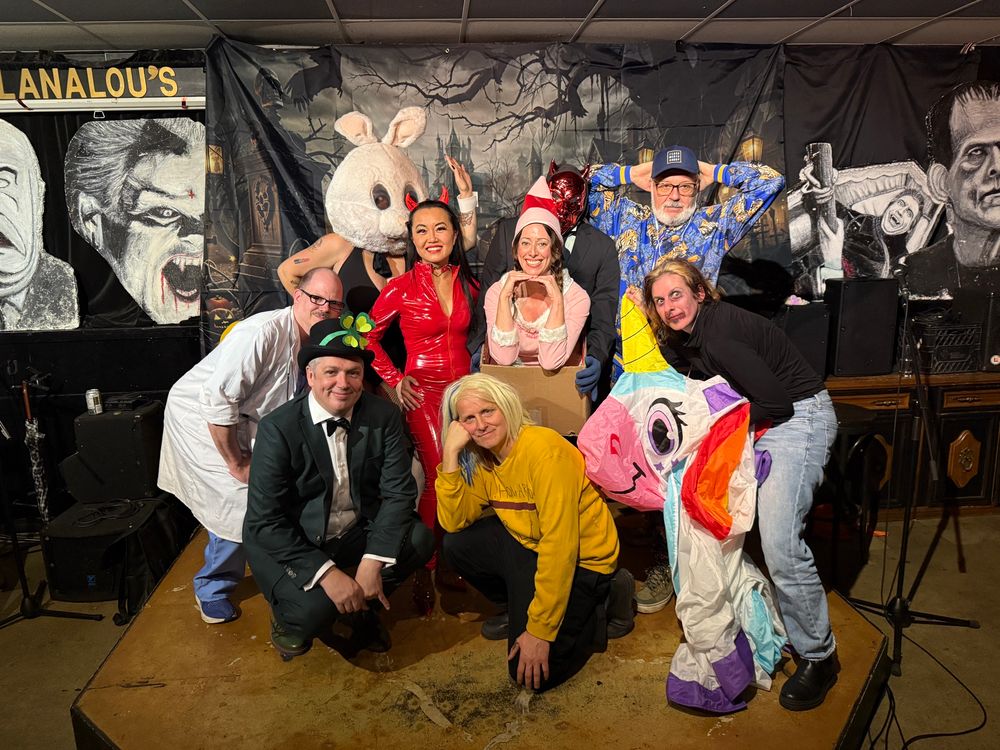 Group photo of Andrew Sutherland, Sean McGarragle, Dina Del Bucchia, Catherine Lewis, Kevin Spenst, Sara Bynoe, Meris Goodfellow, and RC Weslowski, in our Halloween costumes