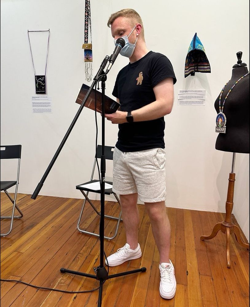 Patrick Grace up at the mic, reading from his book DEVIANT