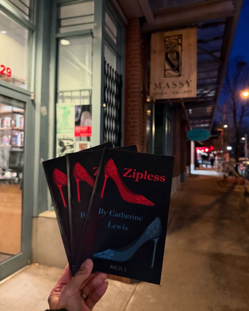 Holding up three copies of my chapbook ZIPLESS outside Massy Books