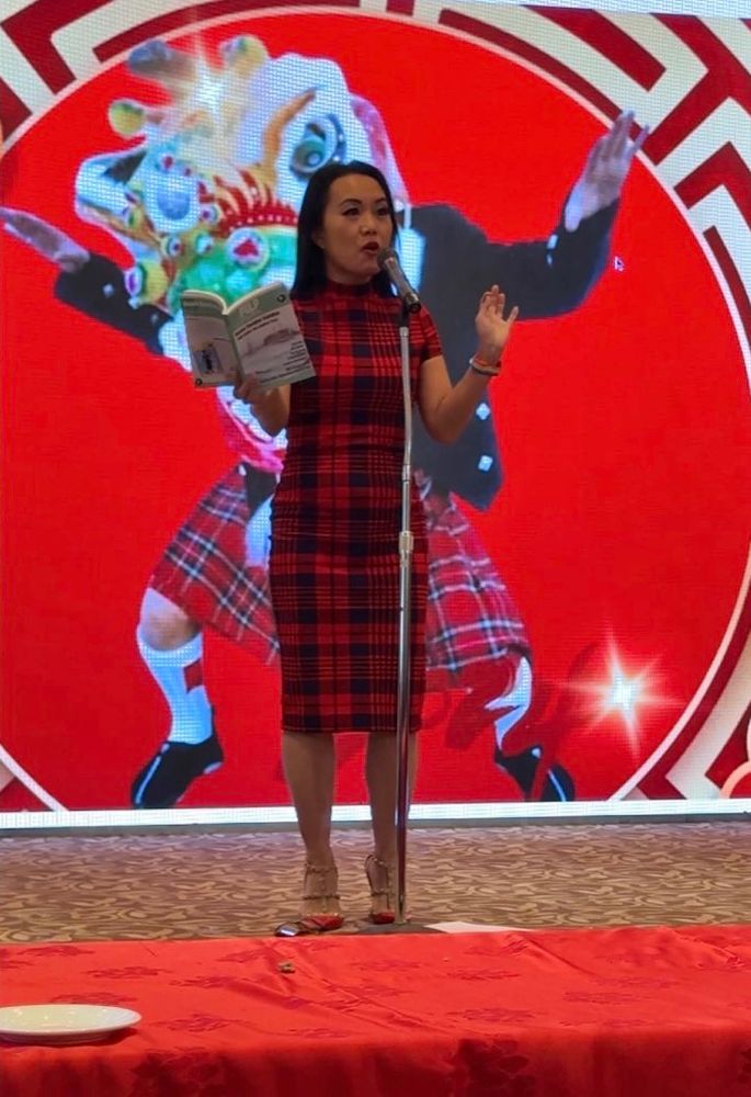 Catherine Lewis reading on stage from Pulp Literature’s Issue 37