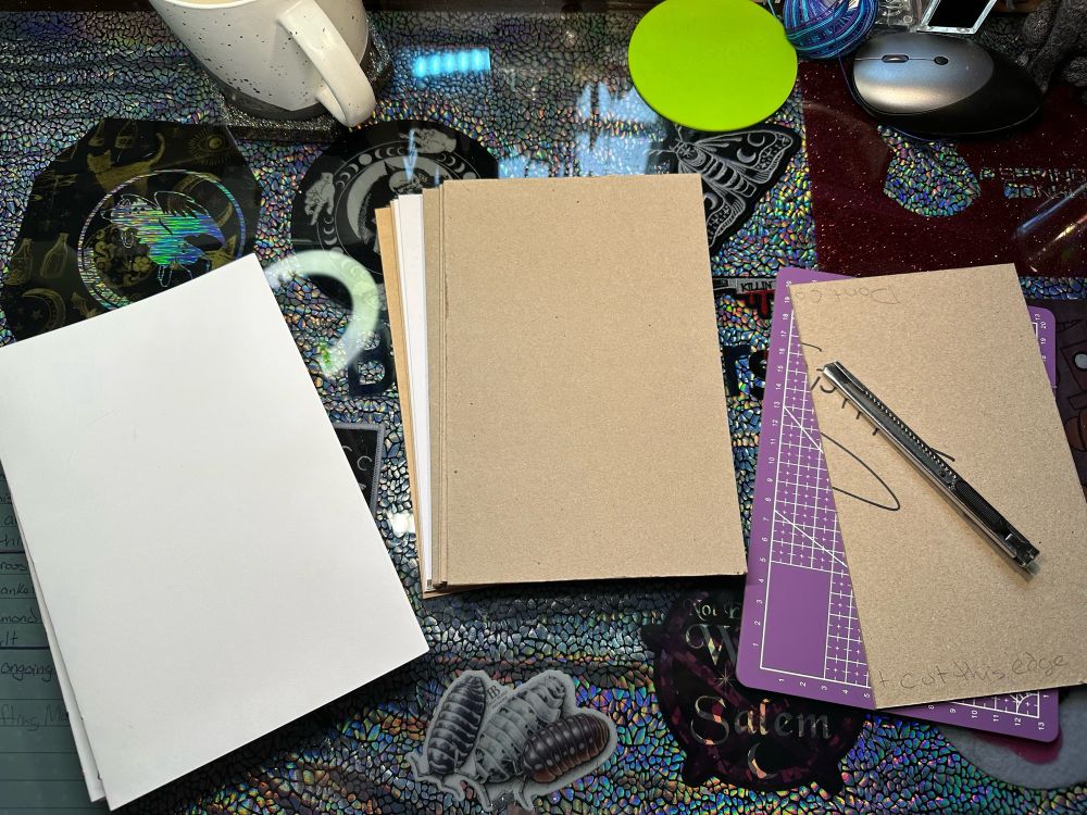 Signatures, end pages, cover boards, and uncut spines on my table, ready for work.