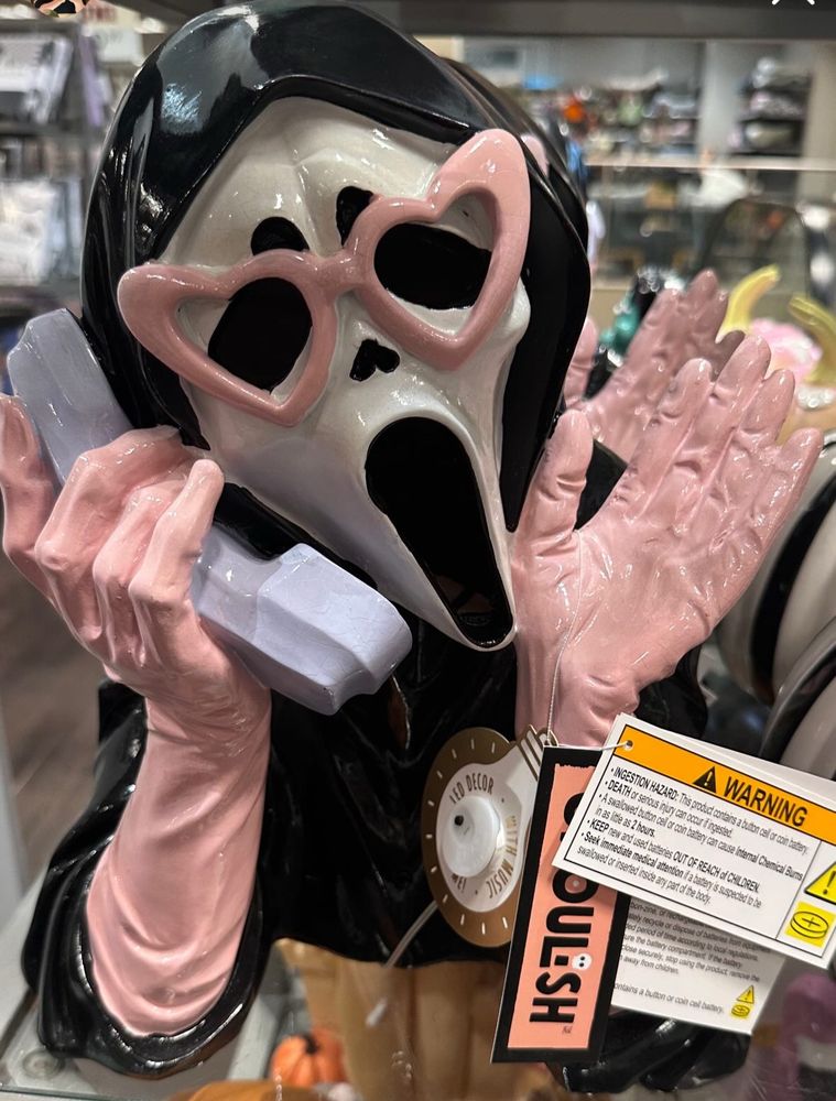 Statue of Ghostface in pink heart glasses and matching gloves