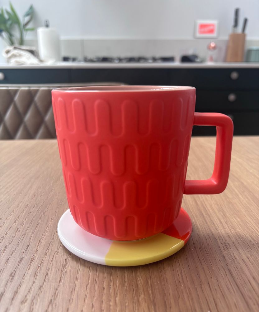 Orange mug with stupid square handle. 