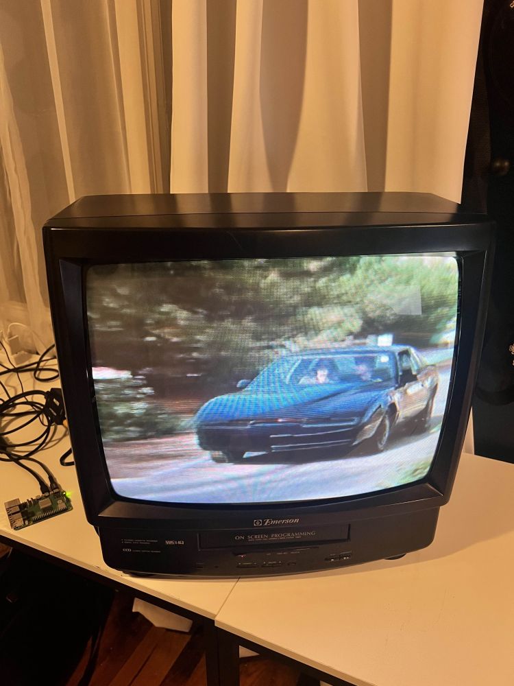 An old CRT television connected to a Raspberry Pi playing Knight Rider as it sits on a desk.