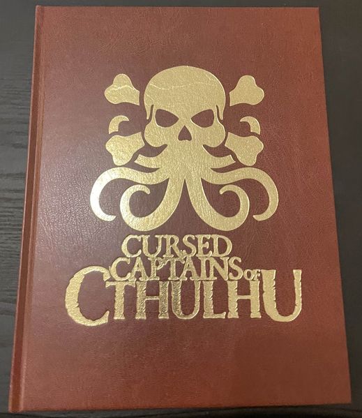 A picture of the front cover of the Cursed Captains of Cthulhu TTRPG book.