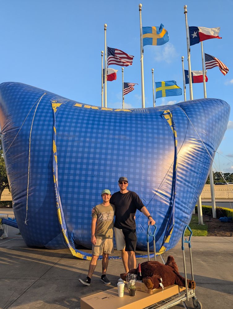 Us posing in front of giant inflatable IKEA tarp bag