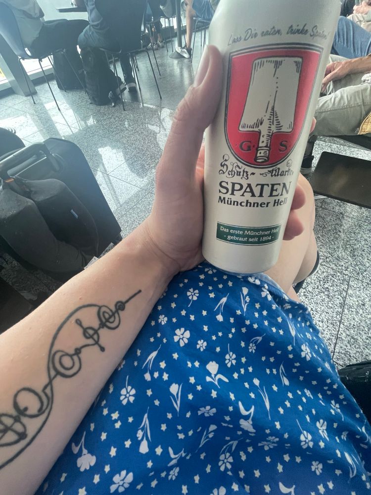 A open can of beer at the airport