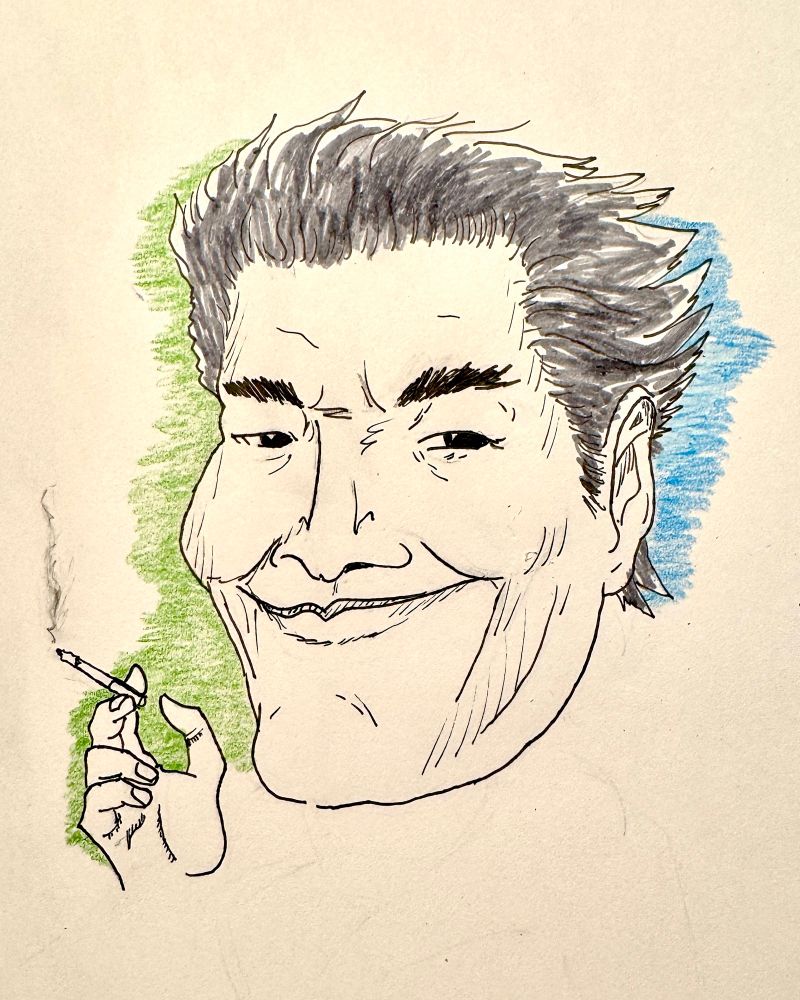 Portrait of Toshiki Inoue. He’s holding a ciggy 