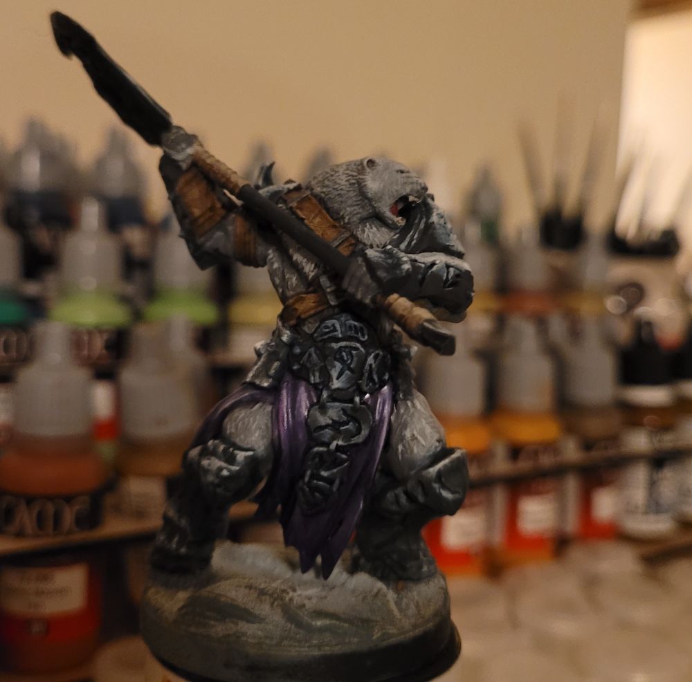 A miniature gaming figure of an anthropomorphic warrior bear.