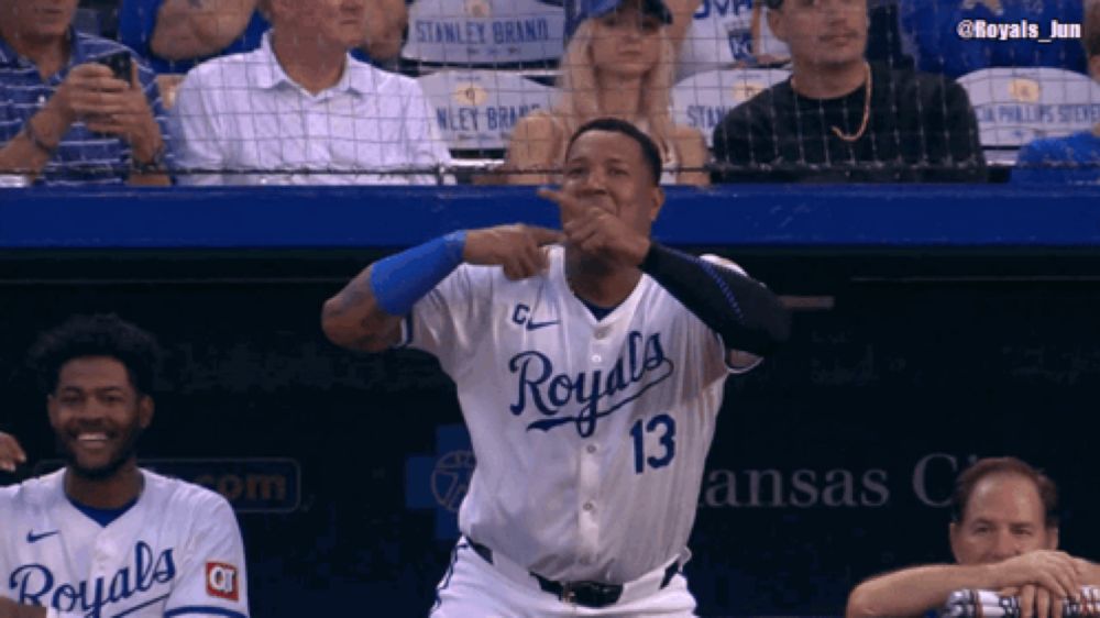 a baseball player wearing a royals jersey is making a funny face