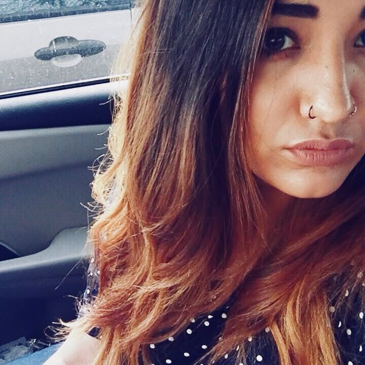 Slime with long hair taking a selfie in her car