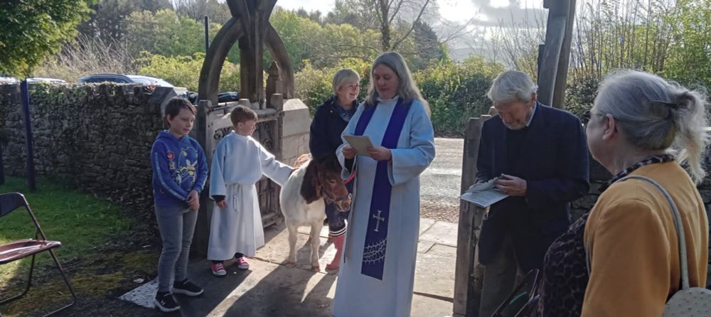 Vicar with pony at lych gate