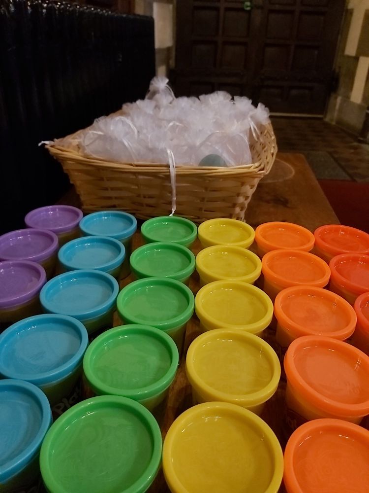 Multiple colourful pots of play doh for use in the prayers of intercession 