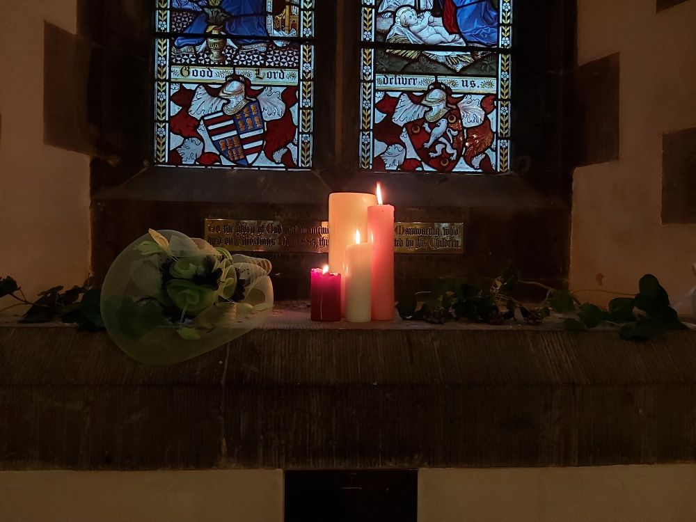 Candles lighting the windows with bouquets next to them