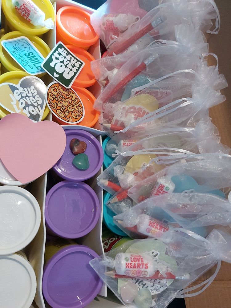 Contents of wedding favours- heart shaped post it notes, pencil, Jesus loves you stickers, gemstone hearts, lovehearts