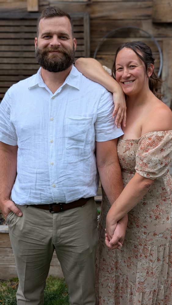 My standing next to my wife after a wedding in semi-formal attire.